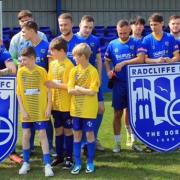 TOGETHERNESS: Senior and junior players mark the link-up at Radcliffe FC. Picture by Peter Lee