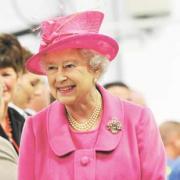 The Queen was dressed in a fuchsia outfit with matching hat, a black bag, gloves and shoes
