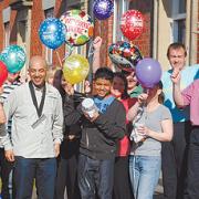HAPPY RETURN: Friends are out in force to welcome back Tahir Khan, second from left