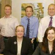 EXPANDING TRADE: Imperial Office Furniture managing director Jeremy Bennett, back row, second left, with staff