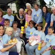Party time: Sue Irwin, front left, the face of Marie Curie, with garden party hosts Kath White (fourth left) and Alison Hargreaves, back left, along with volunteers, visitors and the Mayor and Mayoress of Bolton, Cllr Norman Critchley and his wife,