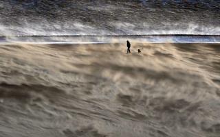 A person walking through a storm. Credit: PA