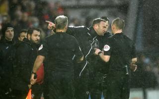 Ian Evatt and the match officials during the game against Morecambe in February.