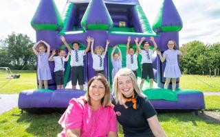 Headteacher Karen Graham (left) and Bellway sales advisor Cath (right) with children on the bouncy castle (002).jpg