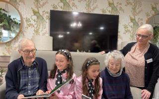 School children share stories with older residents during special visit
