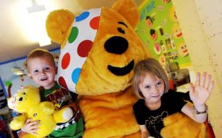 PUDSEY’S PALS: Leon Eardley, aged two, and Georgia Downs, aged four, with Pudsey Bear when he visited the children at Cheeky Monkeys Nursery