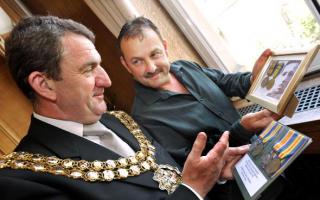 WAR STORIES: Historian Charles Sandbach shows Mayor of Bolton Cllr John Byrne some medals and war memorabilia