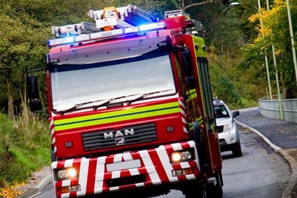 Firefighters battle roof blaze in family home